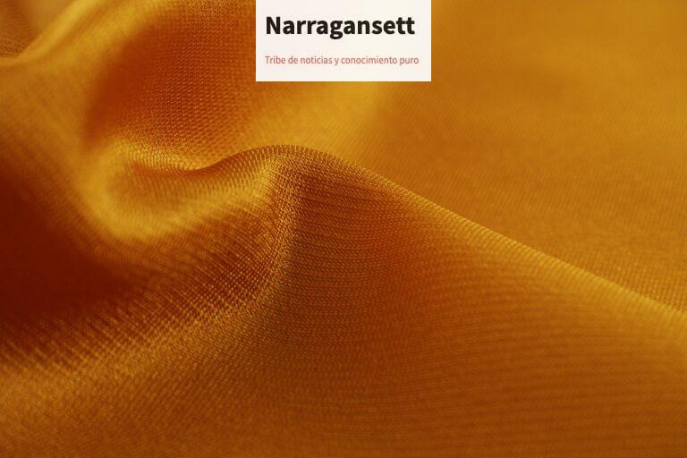 Close-up of a smooth, golden silk fabric showcasing its luxurious texture and shine.