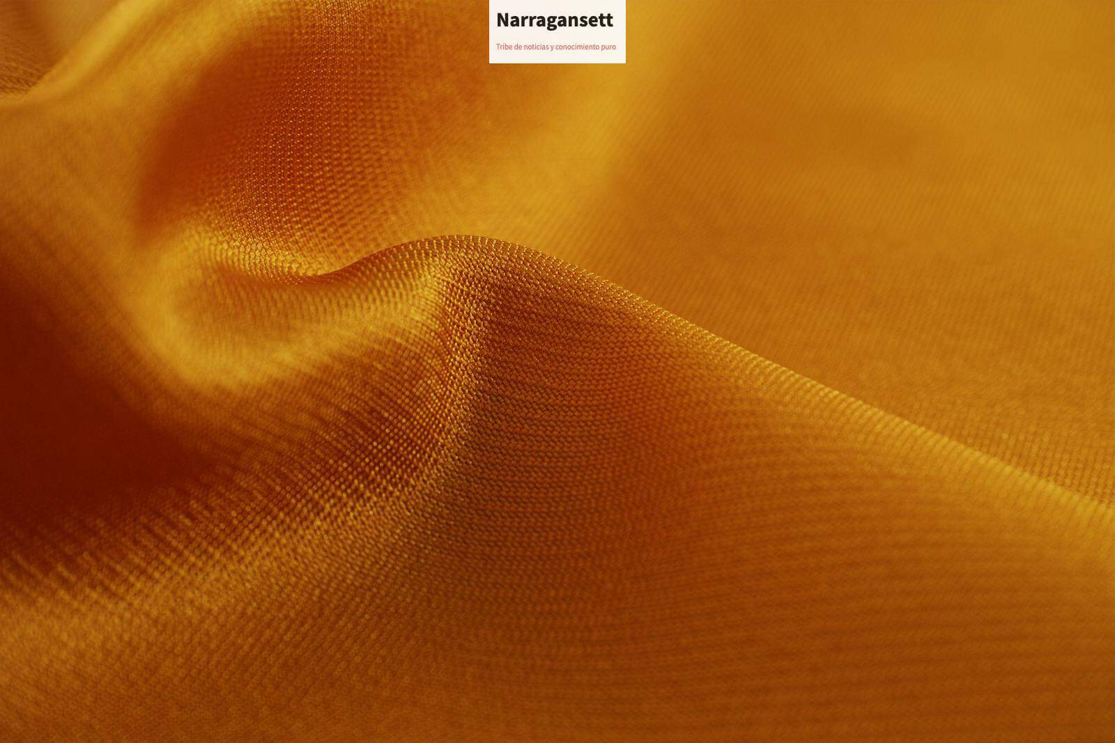 Close-up of a smooth, golden silk fabric showcasing its luxurious texture and shine.