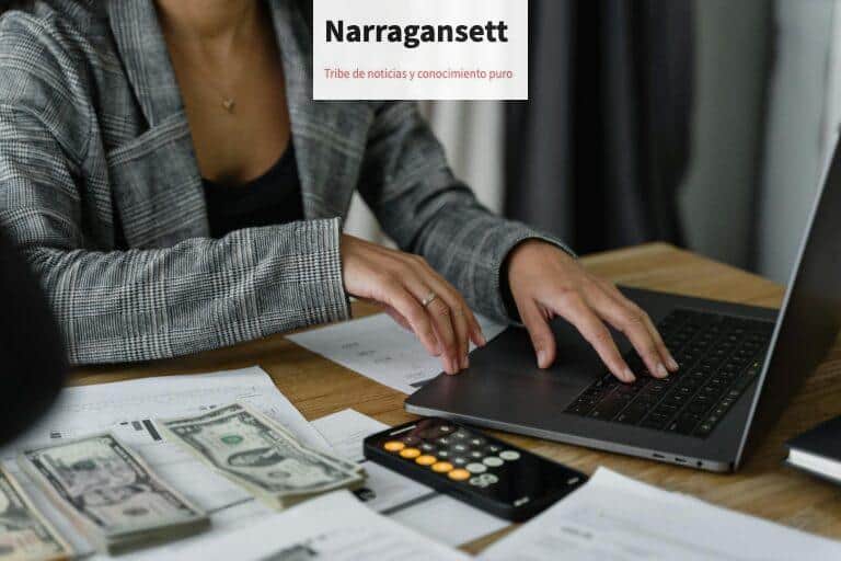 A businesswoman working on finance management with cash and calculator on desk.