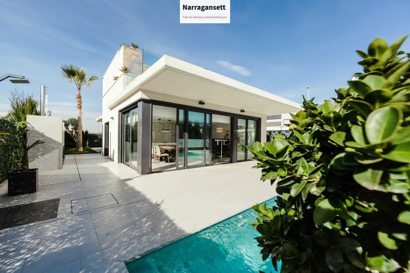 white and grey concrete building near swimming pool under clear sky during daytime